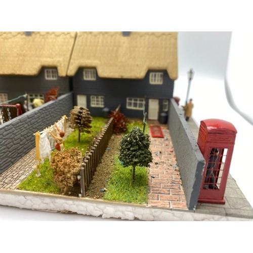 199 - Diorama 'Home sweet home' depicting a terrace of thatched cottages with gardens (1/76 scale), approx... 