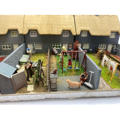 199 - Diorama 'Home sweet home' depicting a terrace of thatched cottages with gardens (1/76 scale), approx... 