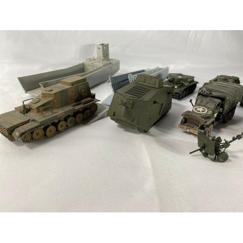 554 - 36 kit-built plastic tanks & military vehicles including two landing craft, nicely built and decorat... 