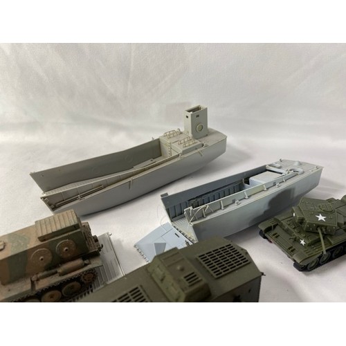 554 - 36 kit-built plastic tanks & military vehicles including two landing craft, nicely built and decorat... 