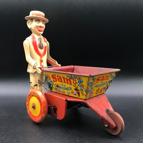 142 - A Marx Toys Sam The Gardener, tinplate and plastic model comprising of red and yellow wheelbarrow wi... 