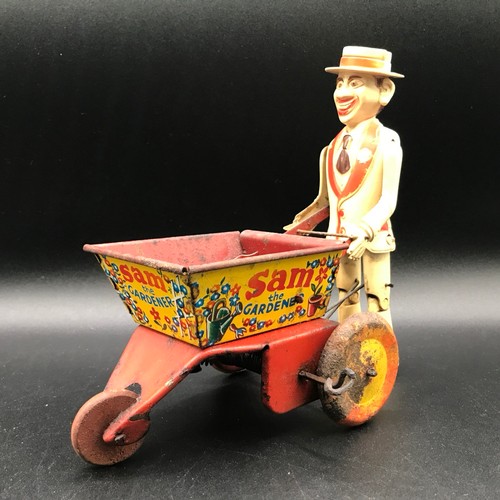 142 - A Marx Toys Sam The Gardener, tinplate and plastic model comprising of red and yellow wheelbarrow wi... 