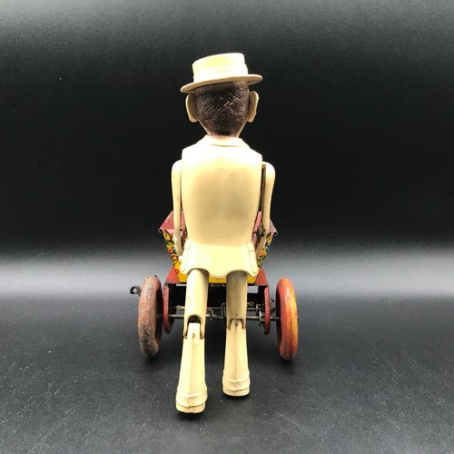 142 - A Marx Toys Sam The Gardener, tinplate and plastic model comprising of red and yellow wheelbarrow wi... 