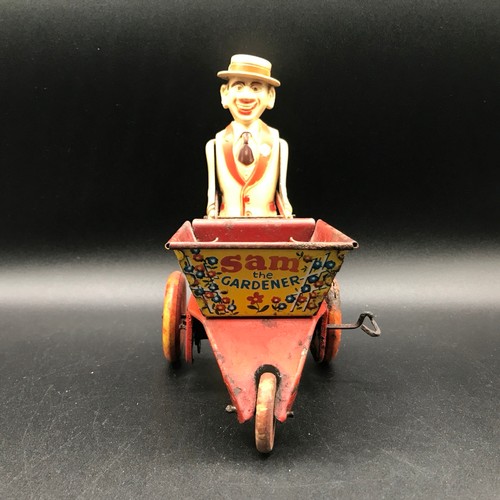 142 - A Marx Toys Sam The Gardener, tinplate and plastic model comprising of red and yellow wheelbarrow wi... 