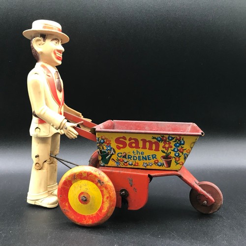 142 - A Marx Toys Sam The Gardener, tinplate and plastic model comprising of red and yellow wheelbarrow wi... 