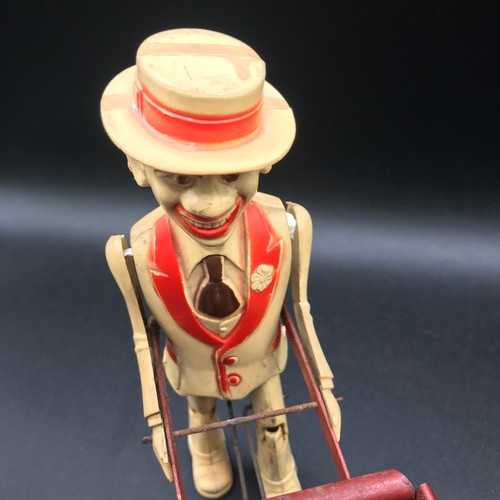 142 - A Marx Toys Sam The Gardener, tinplate and plastic model comprising of red and yellow wheelbarrow wi... 