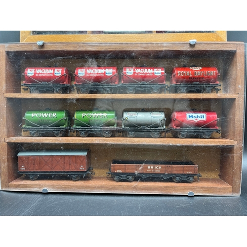 120 - Two wooden display cabinets with 25 Dublo wagons and tankers plus three loose coaches and another tw... 