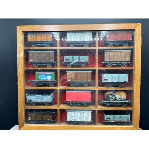 120 - Two wooden display cabinets with 25 Dublo wagons and tankers plus three loose coaches and another tw... 