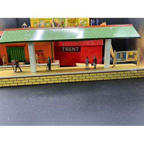 67 - Three Hornby O gauge tin plate trackside buildings and to include 13 O Gauge Dinky Figures shown in ... 