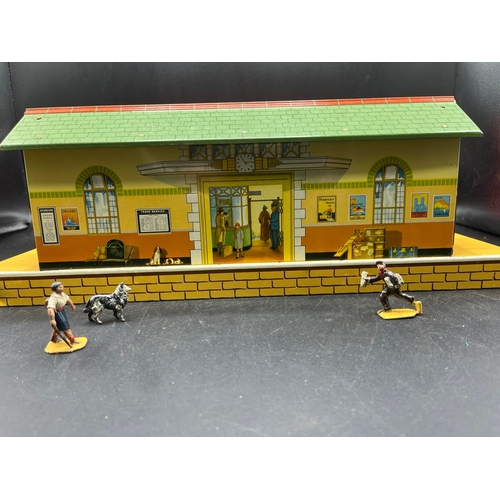 67 - Three Hornby O gauge tin plate trackside buildings and to include 13 O Gauge Dinky Figures shown in ... 