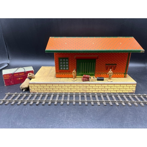 67 - Three Hornby O gauge tin plate trackside buildings and to include 13 O Gauge Dinky Figures shown in ... 