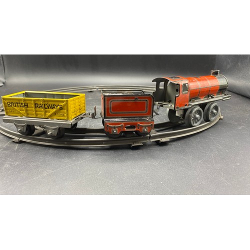 70 - Mettoy Goods Train set includes a circular track of four pieces, Red Tin-plate clockwork loco with t... 