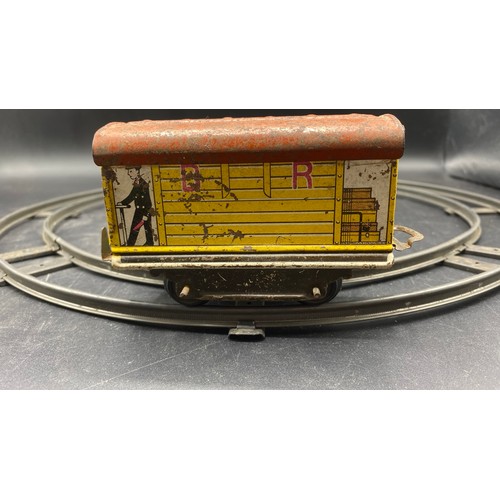 70 - Mettoy Goods Train set includes a circular track of four pieces, Red Tin-plate clockwork loco with t... 