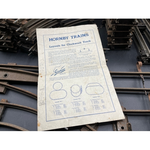 21 - A large quantity of O Gauge Hornby Clockwork track as shown, includes point junction, de-couplers, s... 