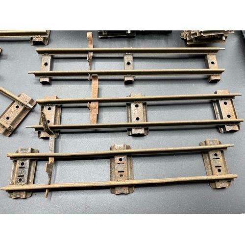 21 - A large quantity of O Gauge Hornby Clockwork track as shown, includes point junction, de-couplers, s... 