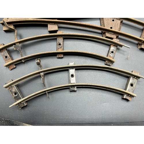 21 - A large quantity of O Gauge Hornby Clockwork track as shown, includes point junction, de-couplers, s... 