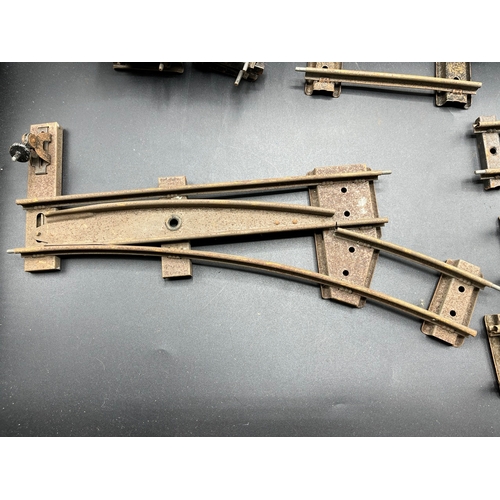 21 - A large quantity of O Gauge Hornby Clockwork track as shown, includes point junction, de-couplers, s... 