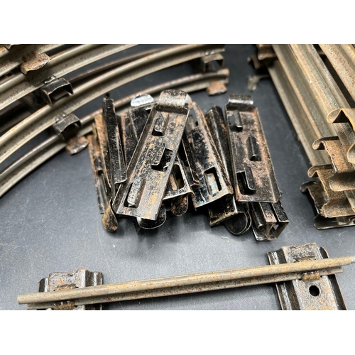 21 - A large quantity of O Gauge Hornby Clockwork track as shown, includes point junction, de-couplers, s... 