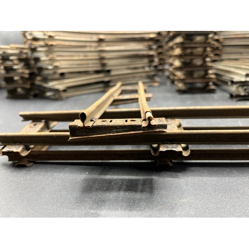 21 - A large quantity of O Gauge Hornby Clockwork track as shown, includes point junction, de-couplers, s... 