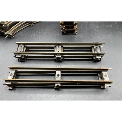 21 - A large quantity of O Gauge Hornby Clockwork track as shown, includes point junction, de-couplers, s... 