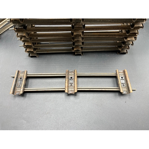 21 - A large quantity of O Gauge Hornby Clockwork track as shown, includes point junction, de-couplers, s... 