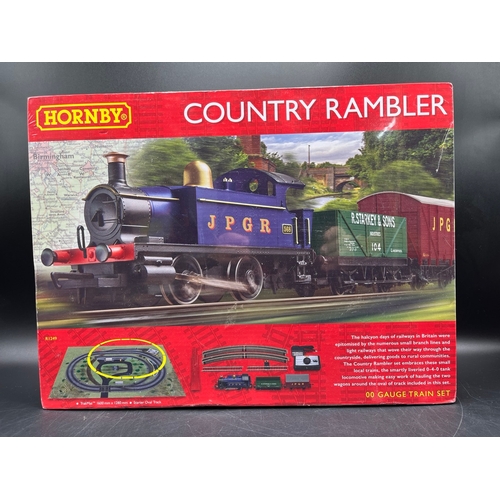 26 - Two Hornby OO Gauge Train Sets, both complete
(3000g)
R1249 Country Rambler, unopened in original sh... 