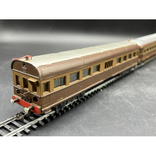 125 - A continental Locomotive, Tram and Railcar each motorised with two Brown/Silver cars/coaches
(2500g)... 