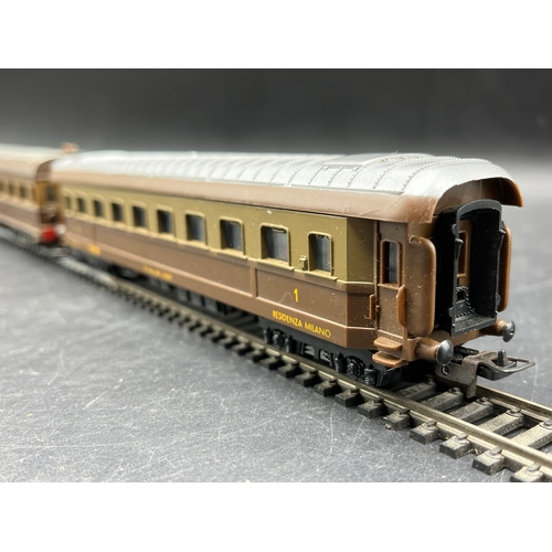 125 - A continental Locomotive, Tram and Railcar each motorised with two Brown/Silver cars/coaches
(2500g)... 