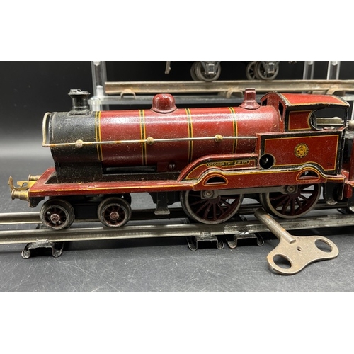 114 - Bing for Bassett-Lowke red LMS 'George V' 4-4-0 loco and tender No. 5320 Clockwork with three Basset... 