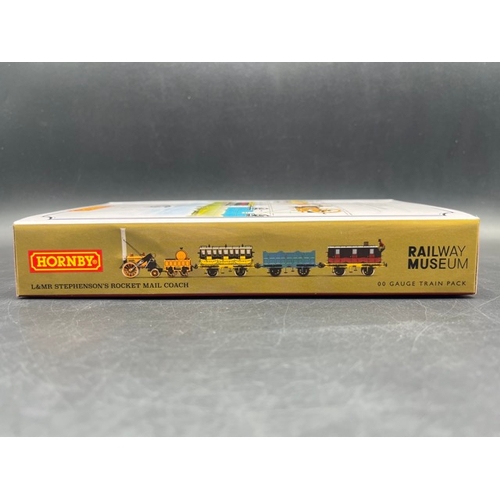 385 - Hornby R3956 Stephenson's Rocket 0-2-2 'Royal Mail' train pack with three Liverpool and Manchester R... 