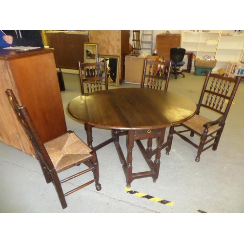 79 - An Oak Gateleg Table with Drawer and 4 Spindle Backed Chairs with Rush Seats