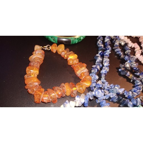 105 - A Quantity of Natural Stone and Amber Necklaces and Bracelets