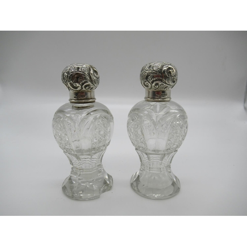 111a - A Matching Pair of Cut Glass and Silver Hallmarked Lidded Scent Bottles ( some chipping as pictured)