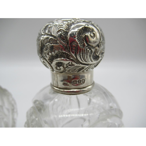 111a - A Matching Pair of Cut Glass and Silver Hallmarked Lidded Scent Bottles ( some chipping as pictured)