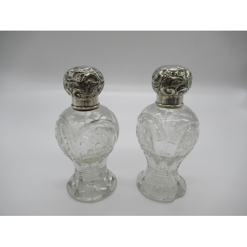 111a - A Matching Pair of Cut Glass and Silver Hallmarked Lidded Scent Bottles ( some chipping as pictured)