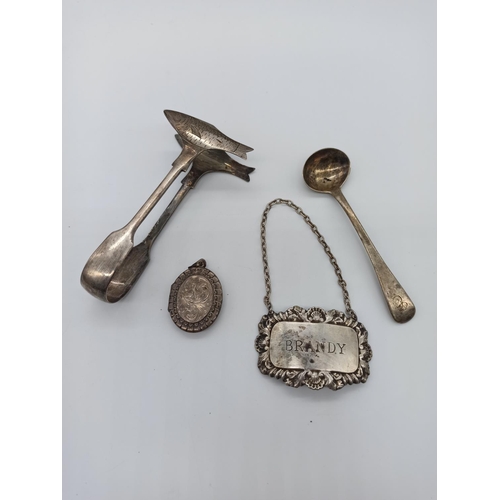 26 - An Assortment of Hallmarked Silverware including Fish Tongs, Decanter Label, Locket and Spoon