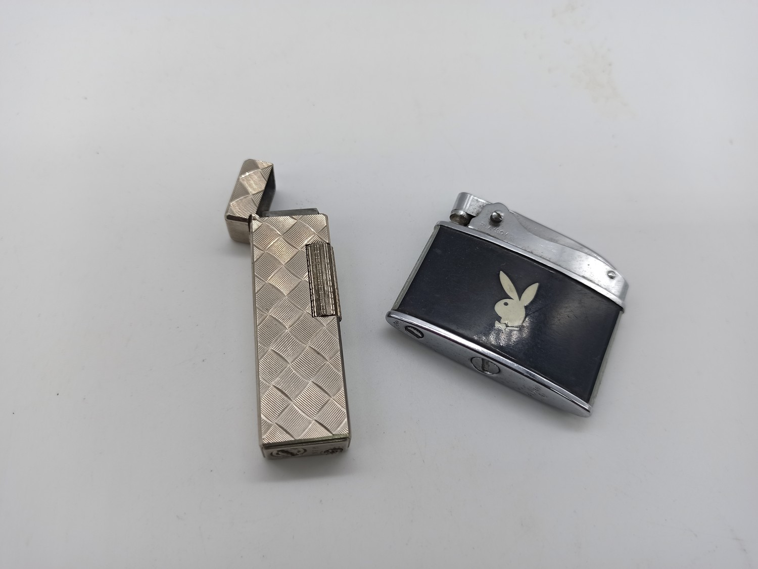 A Vintage WIN and Playboy Cigarette Lighter