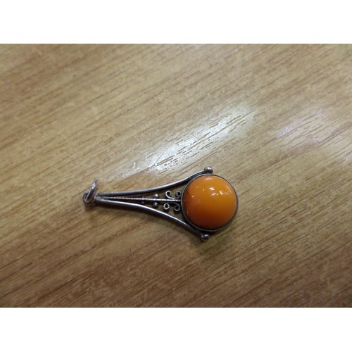 60b - A Sterling Silver and Cabochon Orange Coloured Stone Pendant