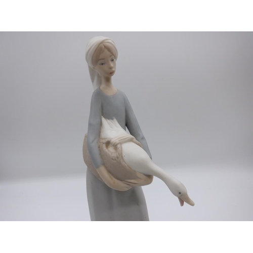 57 - A Lladro Unglazed (Bisque) Figurine of a Girl with Dog and a Goose  (27cm high) plus a Nao Goose ( n... 