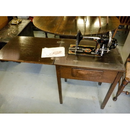 663 - An Antique Frister and Rossman Sewing Machine and Table