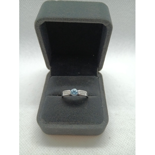 217 - A 9ct White Gold and Blue Topaz Ring with Diamonds to each Shoulder, Size N/O, 3.15gms