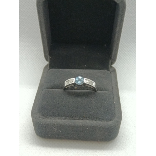 217 - A 9ct White Gold and Blue Topaz Ring with Diamonds to each Shoulder, Size N/O, 3.15gms