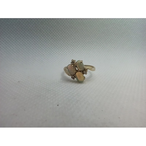 125 - A 9ct Gold Triple Opal Ring set with Diamonds. Size N/O 2.8gms Total Weight