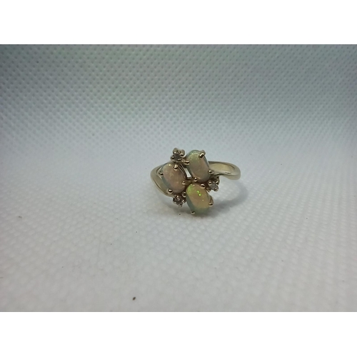 125 - A 9ct Gold Triple Opal Ring set with Diamonds. Size N/O 2.8gms Total Weight