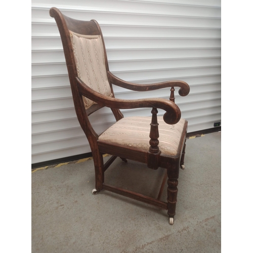 850 - An Oak Scroll Back Armchair on Castors 98cm x 62cm x 57cm