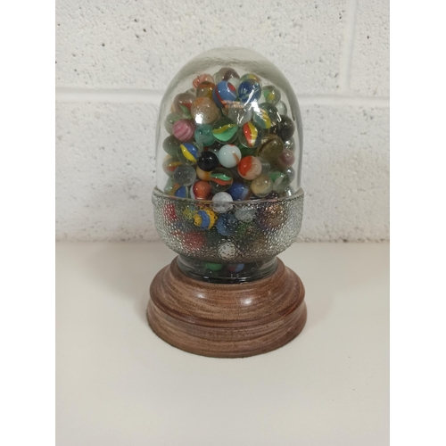 119 - A Glass Acorn on a Wooden Base Full of Marbles 22cm High