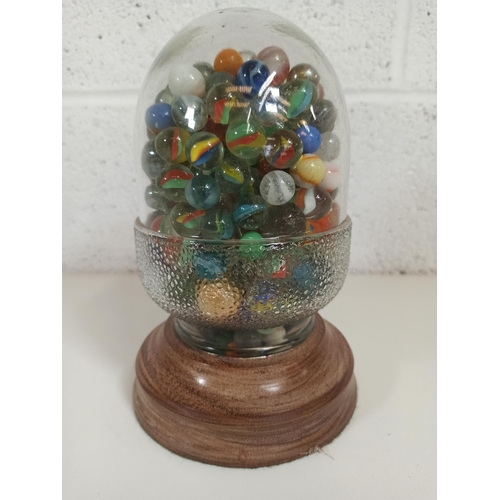 119 - A Glass Acorn on a Wooden Base Full of Marbles 22cm High