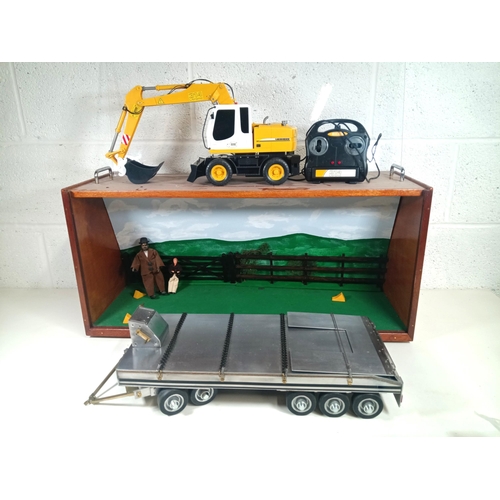 1117 - A Metal Model 10 Wheel Low Loader in Display Case with R.C Model Liebherr Dicke Toy Digger