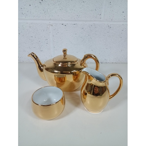 446 - A Royal Worcester Gold Lustre Ware Teapot, Milk Jug and Sugar Bowl