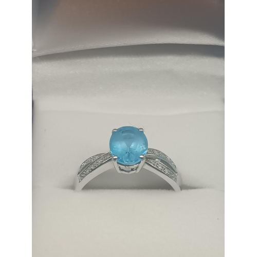 460 - A 9ct White Gold, Blue Topaz and Diamond Ring